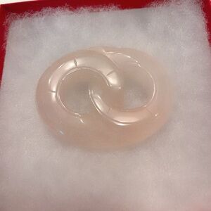 39-gram rose quartz pendant carved into the symbol of infinity